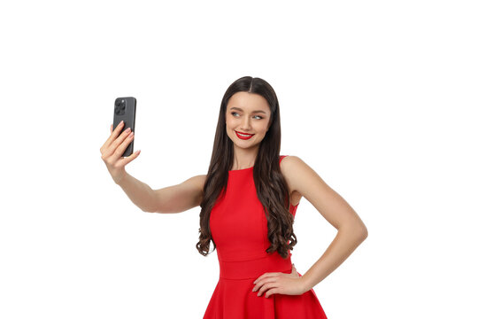 Woman takes a selfie with smartphone while posing, isolated, PNG