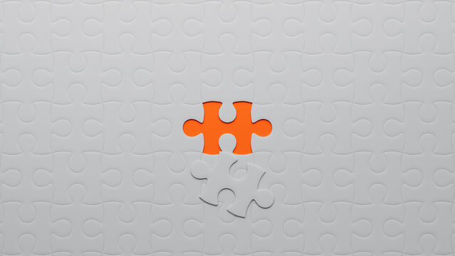 Orange and White Jigsaw Puzzle Wallpaper focusing on the last piece to go into place. Belonging Concept.