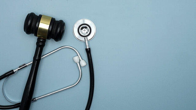 Serious judge gavel and doctor stethoscope showcase ethical medicine malpractice law and justice with solemn clinical legal authority