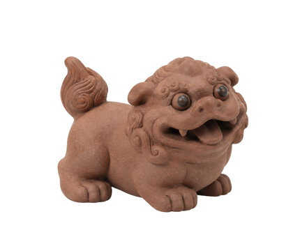 Small brown ceramic foo dog statue with intricate details and a playful expression, isolated on a white background