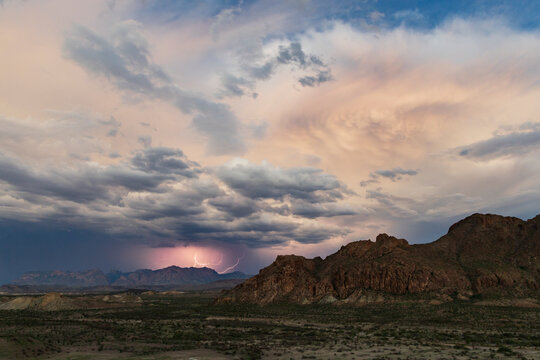Lightning striking over Chisos Mountains in a park