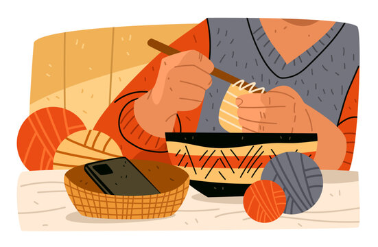 Phone face down while knitting analog hobbies cozy scene with hands knitting yarn balls basket with smartphone slow living crafts home interior