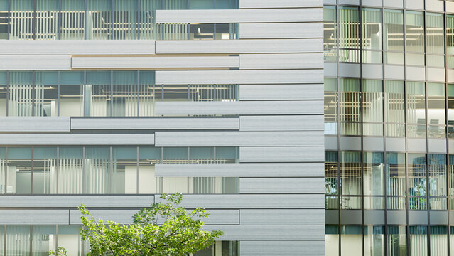 Modern office building exterior with glass windows and steel panels