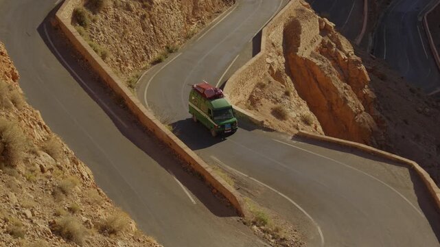 A cinematic video showing a minibus traveling along Morocco's famous winding roads.