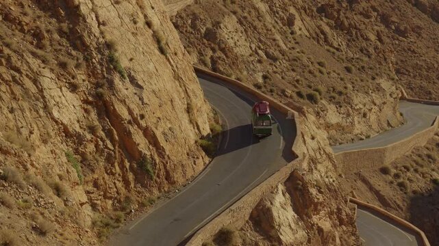 A cinematic video showing a minibus traveling along Morocco's famous winding roads.
