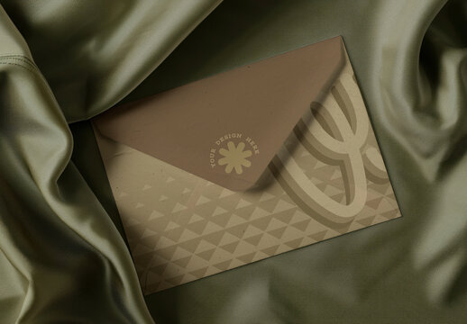 Elegant Envelope Mockup PSD On Olive Satin Fabric Luxury Stationery