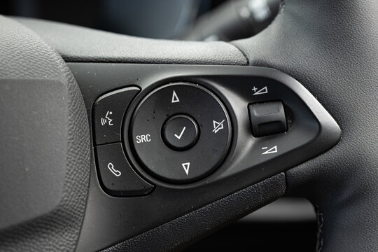 Multifunction steering wheel media buttons with volume control thumbwheel and phone call controls in modern car