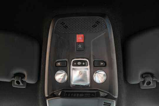 Overhead console control panel with interior reading lights dome light switch and red SOS button in car ceiling