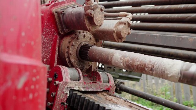 Coiled tubing rig bore drills hole in ground at construction site. Building machinery works on trenches for underground communication systems
