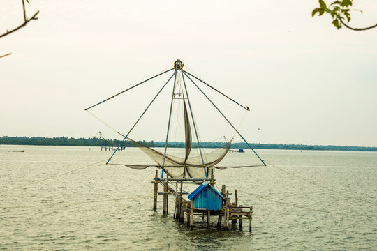 traditional Chinese fishing net, locally known as Cheena Vala, set up on wooden poles in the waters of Fort Kochi, Kerala, India