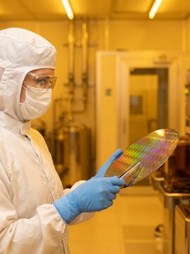 Semiconductor Cleanroom Specialist Inspecting Silicon Wafer Photolithography