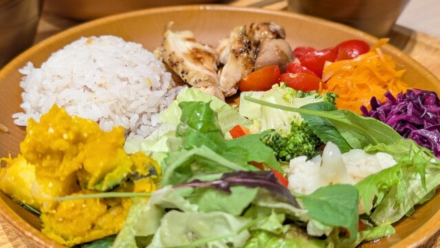 Healthy Japanese lunch plate with grilled chicken, multigrain rice and colorful vegetables
