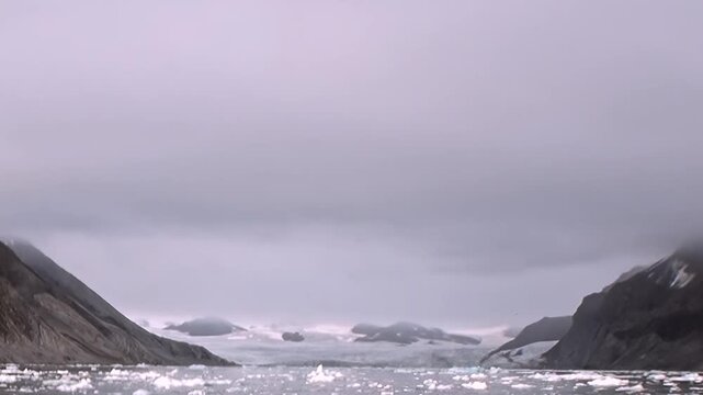 A mountain channel contains floating ice between steep rocky slopes. Additional visible detail includes wide framing, with natural light defining the surrounding forms.
