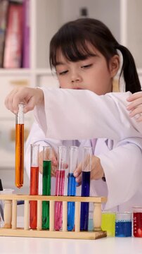 Little Girls in Lab Coats Conducting Science Experiments with Colorful Test Tubes