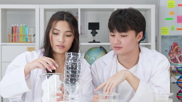 Teenage Students in Lab Coats Conducting Water Filtration Science Experiment