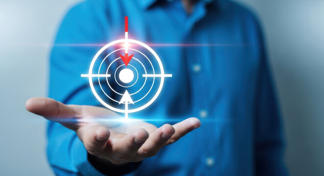 Businessman holding a digital target icon in his hand