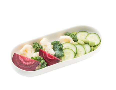 Fresh vegetable salad in white oval bowl featuring sliced red beetroot cucumber cauliflower kale and edamame beans isolated on transparent background for healthy eating diet concepts