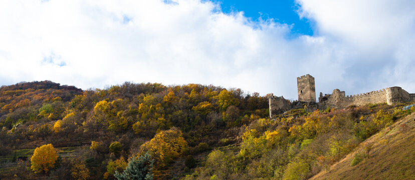 Autumn panorama of medieval Hinterhaus castle ruin on colorful hillside in Wachau Austria