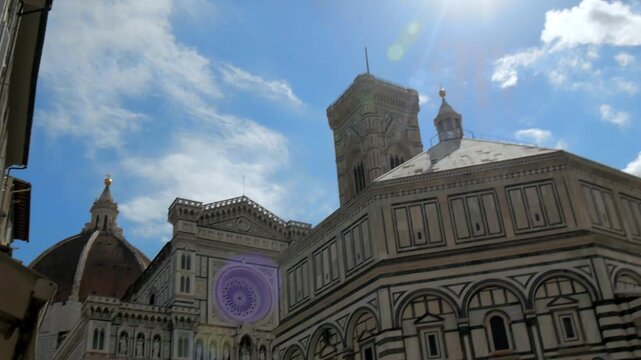 Sun flare on Florence Cathedral and Baptistery facade pan 4K real-time footage
