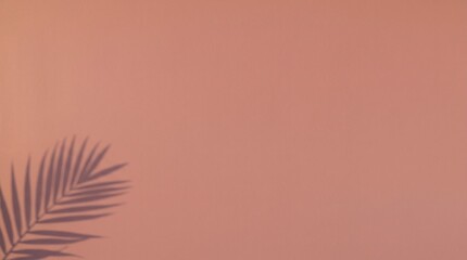 Fototapeta premium Minimalist pink terracotta wall with tropical palm leaf shadow copy space
