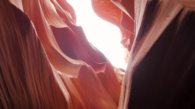 Sunlight illuminating smooth curving red sandstone walls of lower antelope canyon in arizona. Amazing display of light and shadow within the famous narrow slot canyon miracle of nature