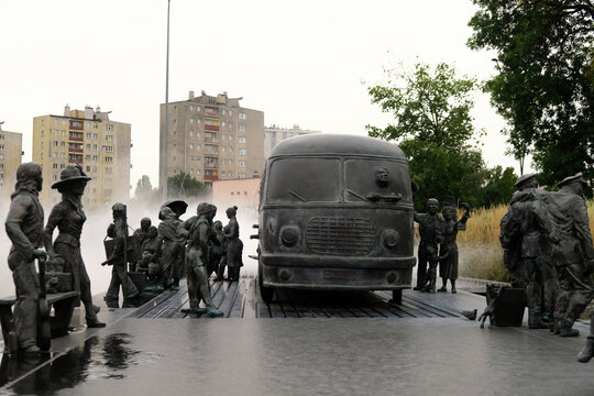 Kielce, Poland.  A sculpture by Sławomir Mick in front of the Kielce train station, featuring, among others, a Jelcz 43, commonly known as the "cucumber"