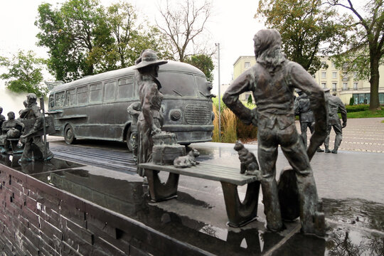 Kielce, Poland.  A sculpture by Sławomir Mick in front of the Kielce train station, featuring, among others, a Jelcz 43, commonly known as the "cucumber"