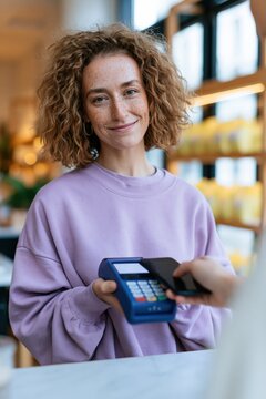 Contactless payment interaction with smiling cashier and customer using card reader for retail checkout banner and background design