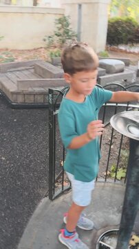Young Boy Exploring a Playground in an Urban Park