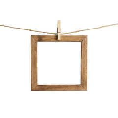 Wooden square picture frame hanging on a rope with a clip © Raja