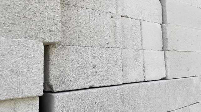 Low angle view of stacked white lightweight concrete blocks