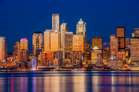 Seattle skyline at night with illuminated skyscrapers and waterfront