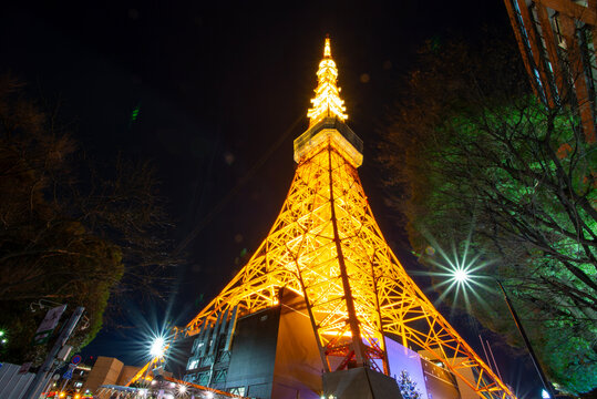 Tokyo, Japan - January 10, 2018: A low-angle view captures the brightly illuminated Tokyo Tower against a dark night sky.