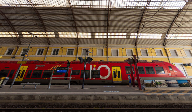 Avignon, France - December 28, 2025: A red and yellow liO TER train waits at the platform inside Avignon Centre Station.