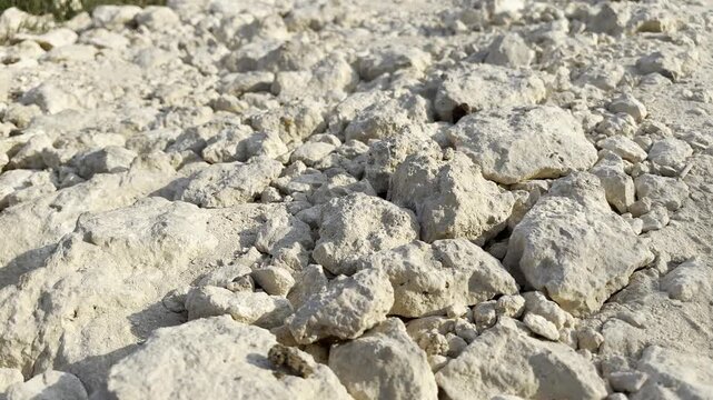 Wide shot of dry limestone rocks on the ground