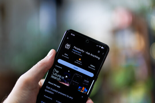 Hand holds phone displaying app store screen for Perplexity - Ask Anything