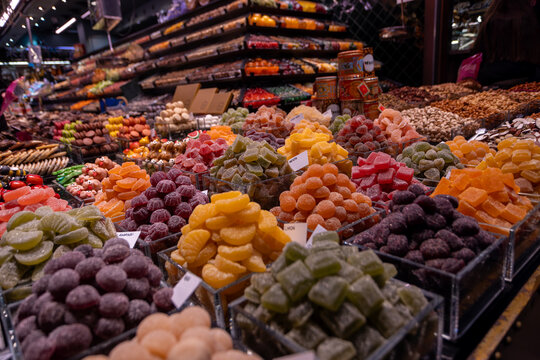 Barcelona, Spain - A vibrant display of colourful candied fruit and sweets at La Boqueria market.