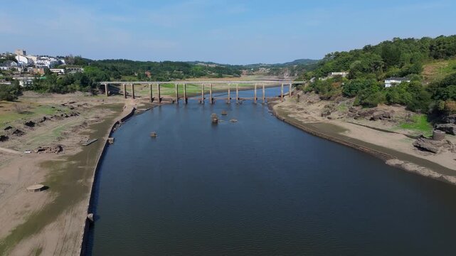 A Scenic View of the River and Surrounding Countryside in San Miguel, Portomar&iacute;n, Spain - Orbit Drone Shot