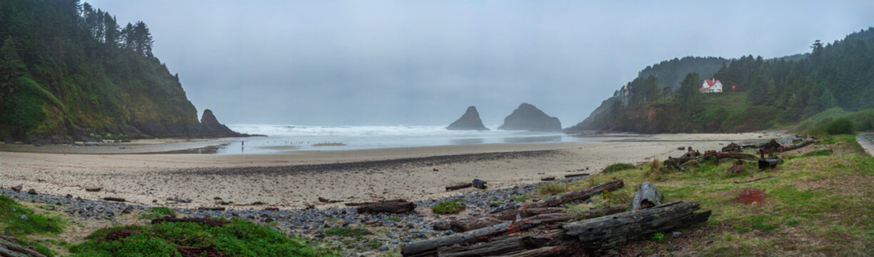 Beautiful wide panoramic view of a wild ocean coast with a secluded house on a misty hill
