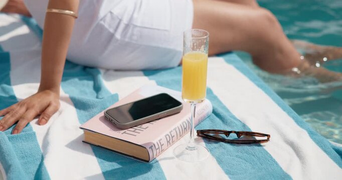 Person, hands and vacation with drink in swimming pool for holiday getaway or summer break. Travel, accommodation and relax by poolside with juice for luxury weekend or hospitality in spa or resort