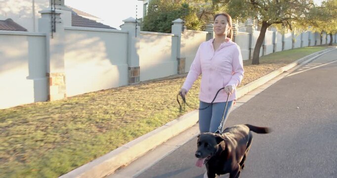 Lifestyle videos outdoor of people doing activities, walking black dog, woman enjoying morning strol