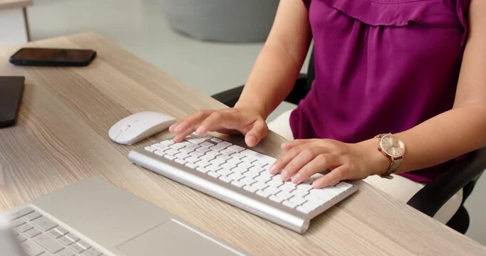 Lifestyle videos indoor of people doing activities at office, typing on keyboard, woman working at d