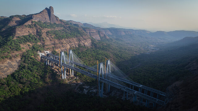 Daytime view of the Mumbai&ndash;Pune Missing Link bridge section on the expressway, showcasing modern highway infrastructure cutting through hilly terrain. 