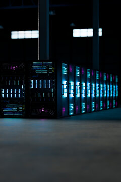 3D glowing server aisle corner with cyan and magenta data light