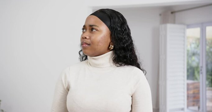 High speed photography for dynamic scenes, standing indoors, woman in turtleneck sweater looking con
