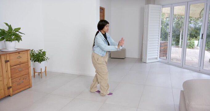 High speed photography for dynamic scenes, in living room, young girl pulling with arm