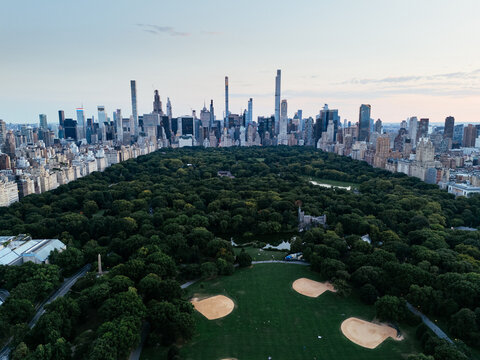 Aerial view of Central Park surrounded by Manhattan skyscrapers and New York City skyline.