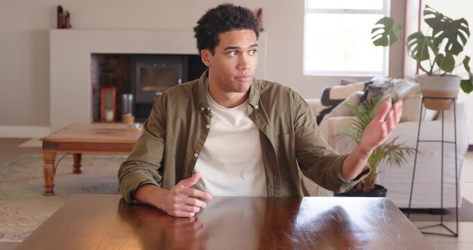 Close up of people talking to the camera, Man sitting at table, talking and gesturing with hands in