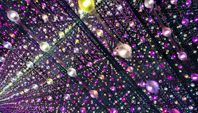 immersive space glowing geometric shapes, lights, and mirrors, geometric shapes floating nearby, abstract cosmic backdrop