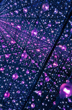 immersive space glowing geometric shapes, lights, and mirrors, geometric shapes floating nearby, abstract cosmic backdrop